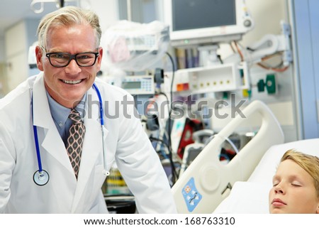 Male Doctor With Sleeping Patient In Emergency Room