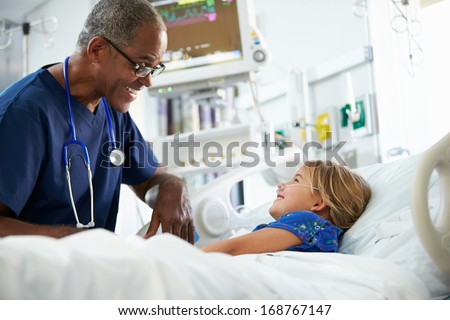 Young Girl Talking To Male Nurse In Intensive Care Unit