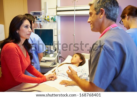 Mother And Daughter With Medical Staff In Hospital Room
