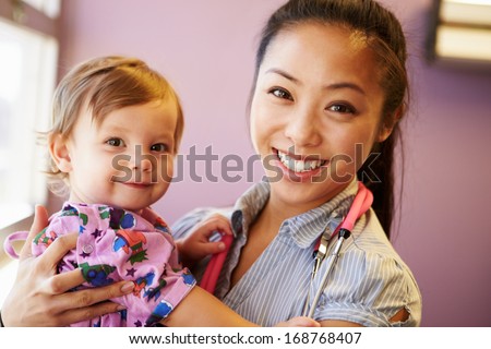 Young Girl Being Held By Female Pediatric Doctor