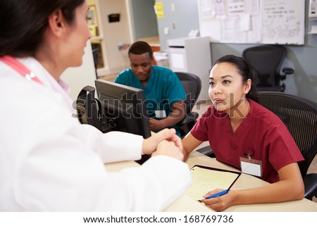 Medical Staff Meeting At Nurses Station