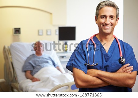 Portrait Of Male Doctor With Patient In Background