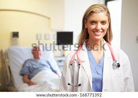 Portrait Of Female Doctor With Patient In Background