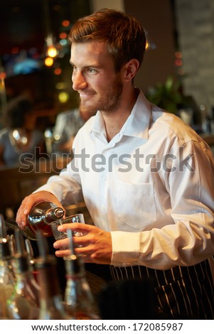 Barman Serving Drinks In Nightclub