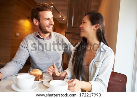 Couple Meeting In Busy Cafe Restaurant