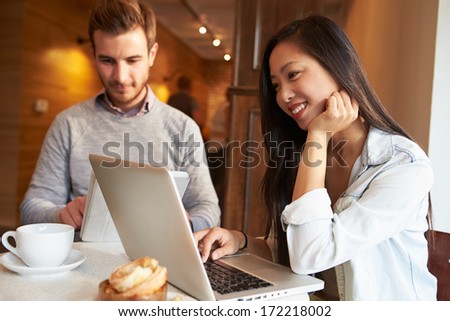 Couple Meeting In Busy Cafe Restaurant