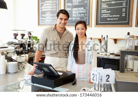 Male And Female Staff In Coffee Shop