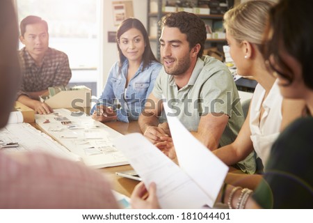 Six Architects Sitting Around Table Having Meeting