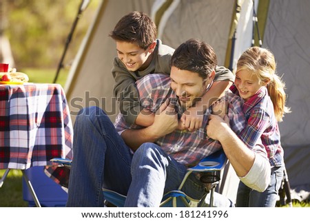 Father And Children Enjoying Camping Holiday In Countryside