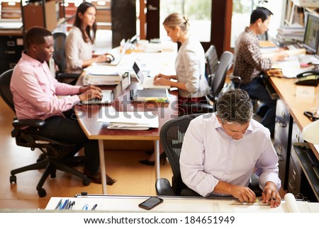 Interior Of Busy Architect\'s Office With Staff Working