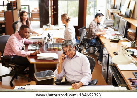 Interior Of Busy Architect\'s Office With Staff Working