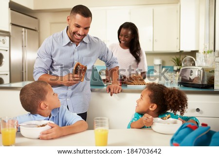 Family Eating Breakfast At Home Together