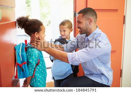 Father Saying Goodbye To Children As They Leave For School