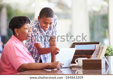 Grandson Helping Grandmother With Laptop