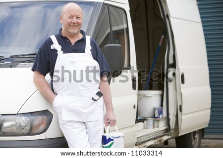 Decorator Standing Next To White Van