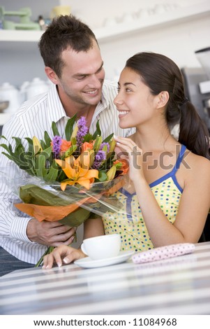 Man giving woman bouquet of flowers