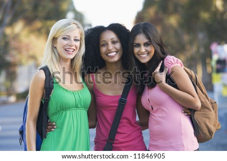 Group of three female friends having fun off campus