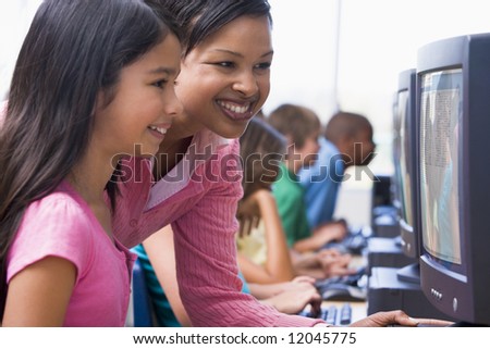 Elementary school computer class with teacher