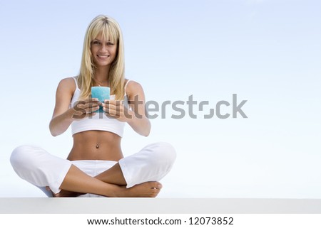 Woman meditating outside holding candle