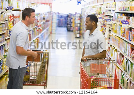 Two men meeting and talking in supermarket