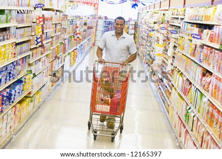 Young man grocery shopping in supermarket