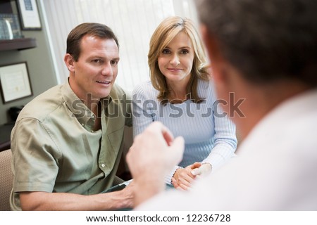 Couple in consultation at IVF clinic talking to doctor