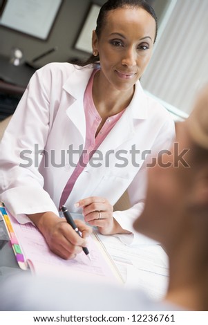 Doctor in consultation with patient in IVF clinic sitting at desk