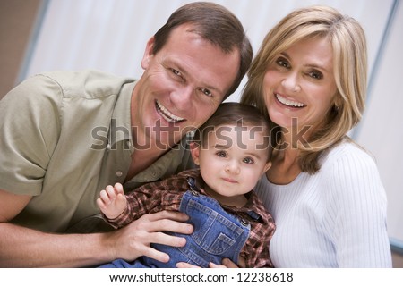 Mother and father with young son at home