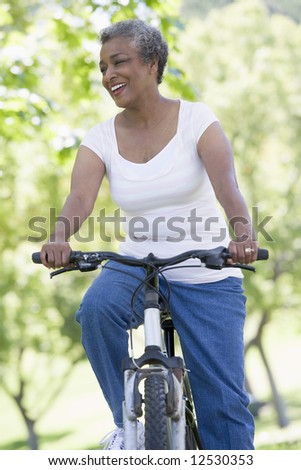 Senior woman on cycle ride in countryside