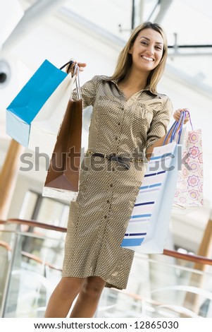 Woman shopping in mall carrying bags