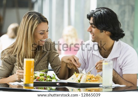 Couple enjoying lunch sitting at cafe table Couple enjoying lunch sitting at cafe table