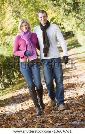 Young couple on walk through autumn woods