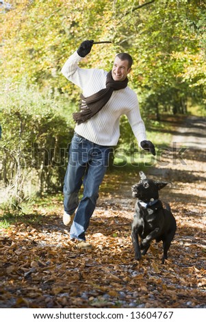 http://image.shutterstock.com/display_pic_with_logo/187633/187633,1212080862,1/stock-photo-man-exercising-dog-in-autumn-woodland-13604767.jpg