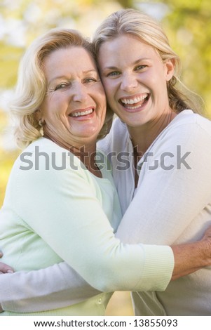 Mother hugging grown up daughter