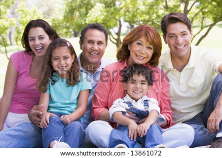 Extended family sitting outdoors smiling