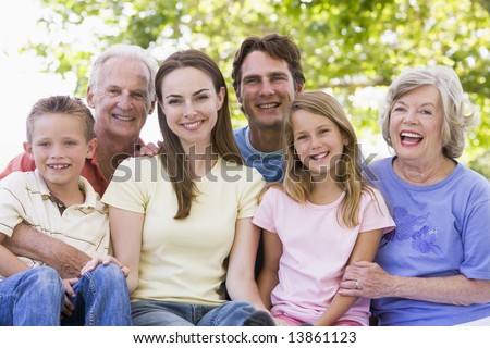 Extended family outdoors smiling