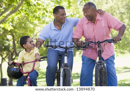 Grandfather grandson and son bike riding