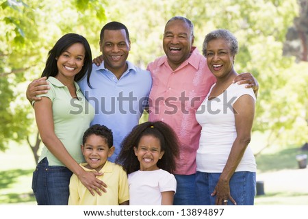 Extended family standing in park smiling