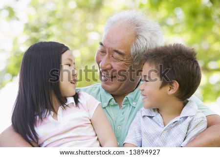 Grandfather laughing with grandchildren