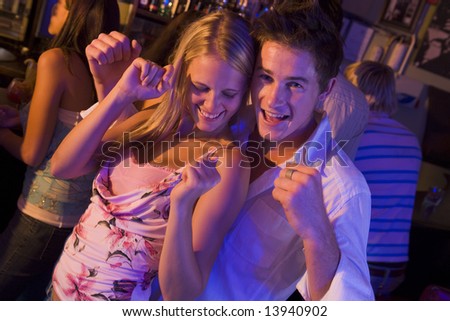Young man and young woman dancing in a nightclub