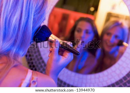 women in makeup. women applying makeup in a