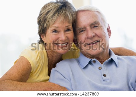 Couple relaxing in living room smiling