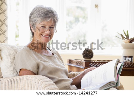 Living Room on Woman In Living Room Reading Book Smiling Stock Photo 14241277