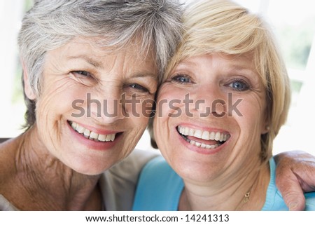 Two women in living room smiling