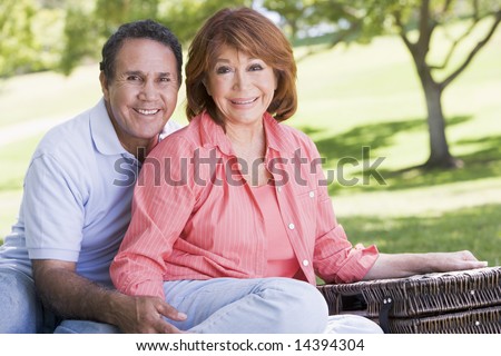 Couple at a picnic holding hands and smiling