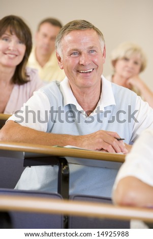 Senior man listening to a university lecture