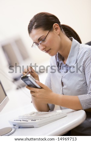 Woman in computer room using personal digital assistant