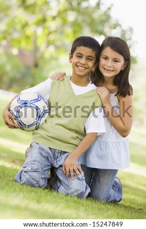Cotton ball in good grades This phototwo children playing gaelic football 