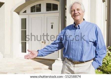 Senior man welcoming visitor to home