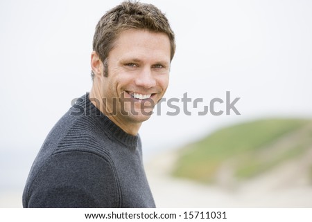 Man standing at beach smiling